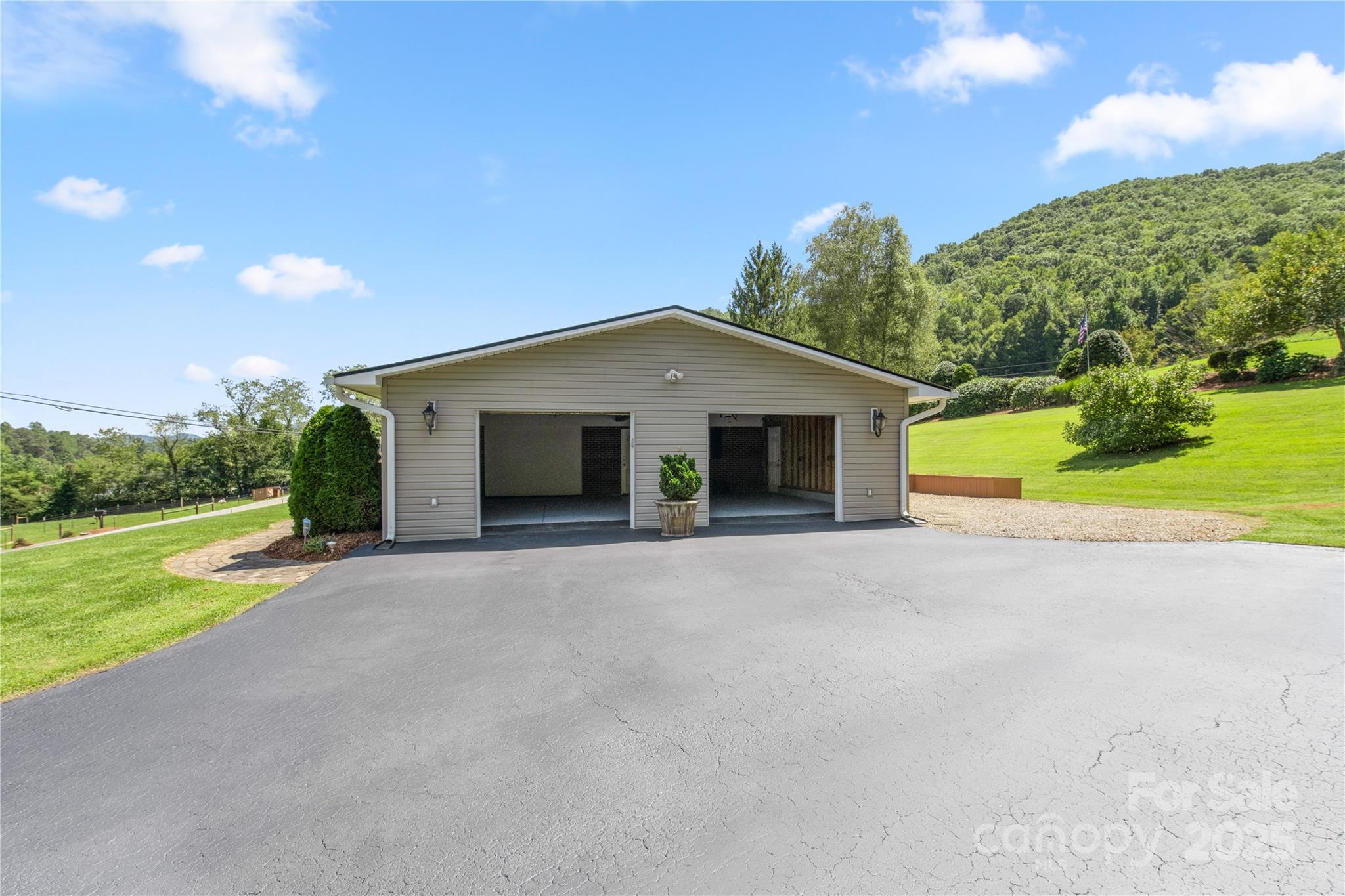 111 Curtis Creek Road Candler, NC 28715 - Photo 2 of 28 a view of a house with backyard and a garden