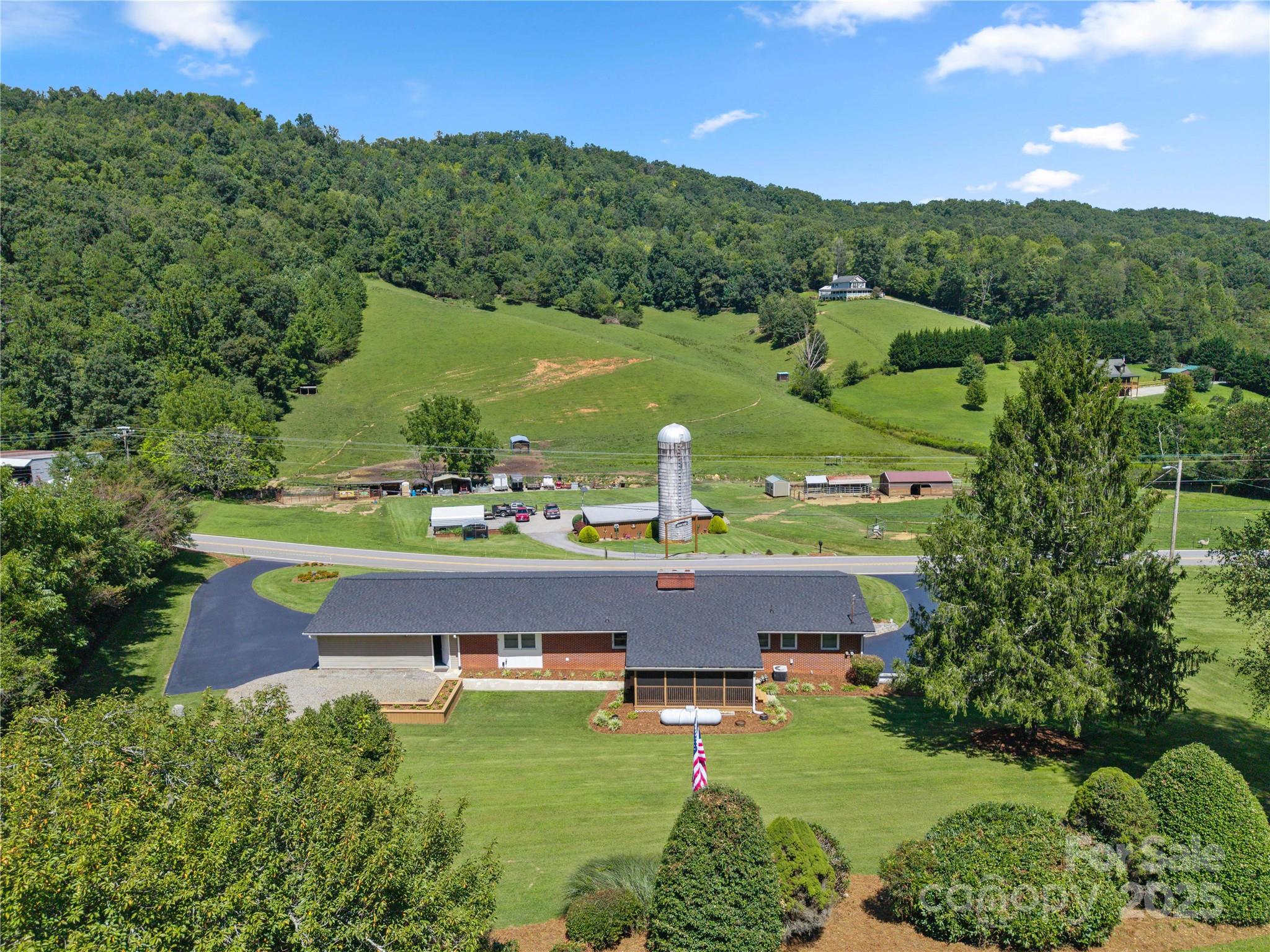 111 Curtis Creek Road Candler, NC 28715 - Photo 28 of 28 an aerial view of a house with a yard