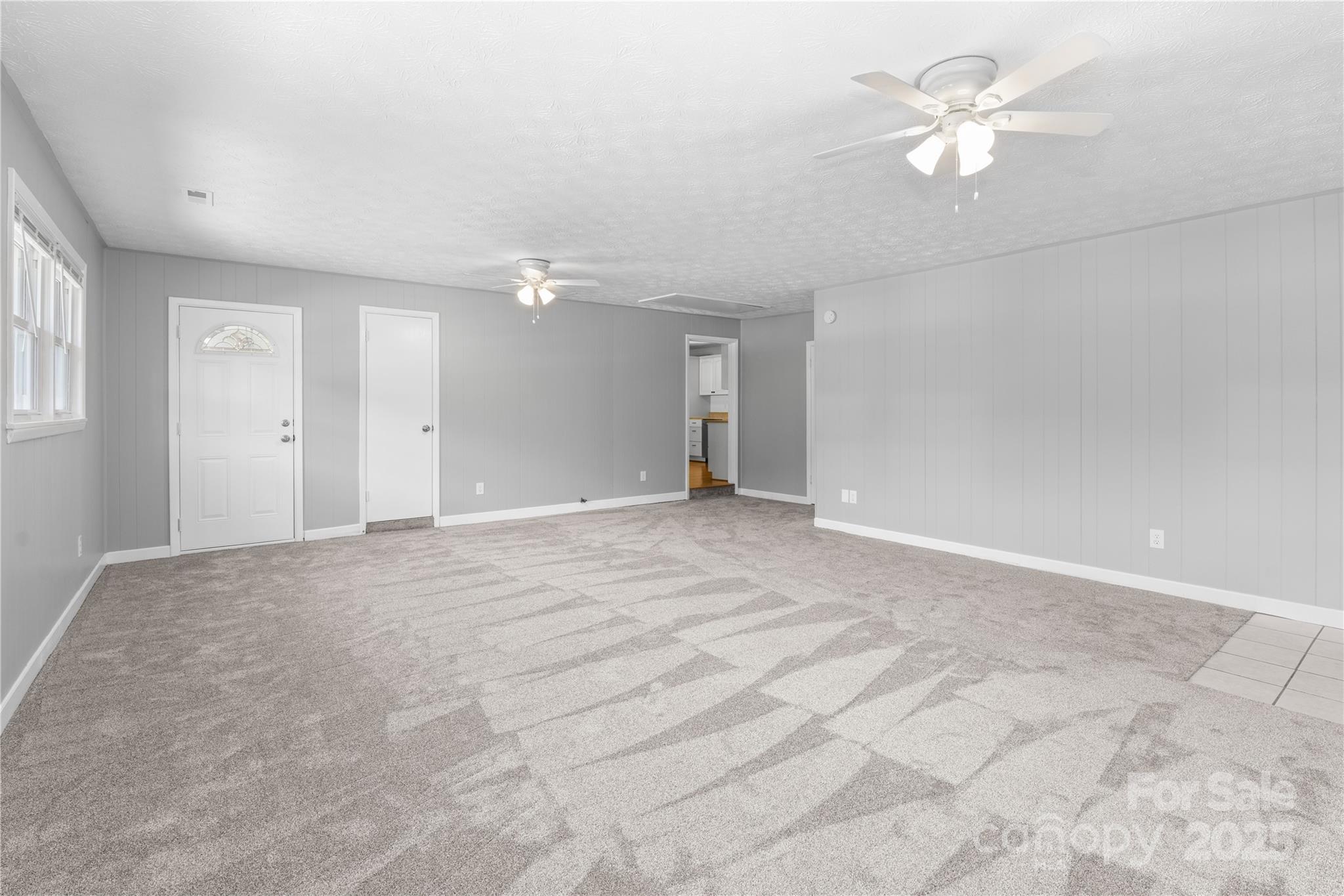 111 Curtis Creek Road Candler, NC 28715 - Photo 3 of 28 a view of an empty room with a ceiling fan