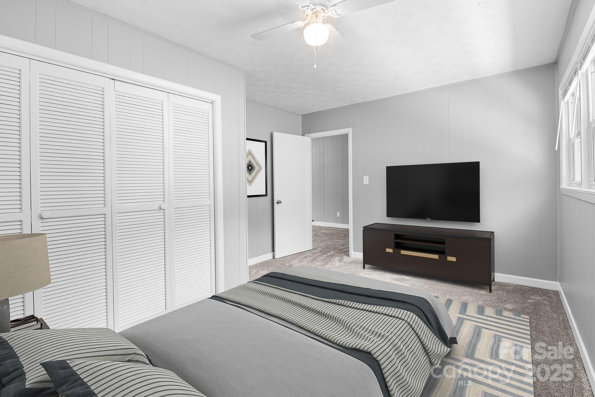 111 Curtis Creek Road Candler, NC 28715 - Photo 7 of 28 a bedroom with a bed and a flat screen tv