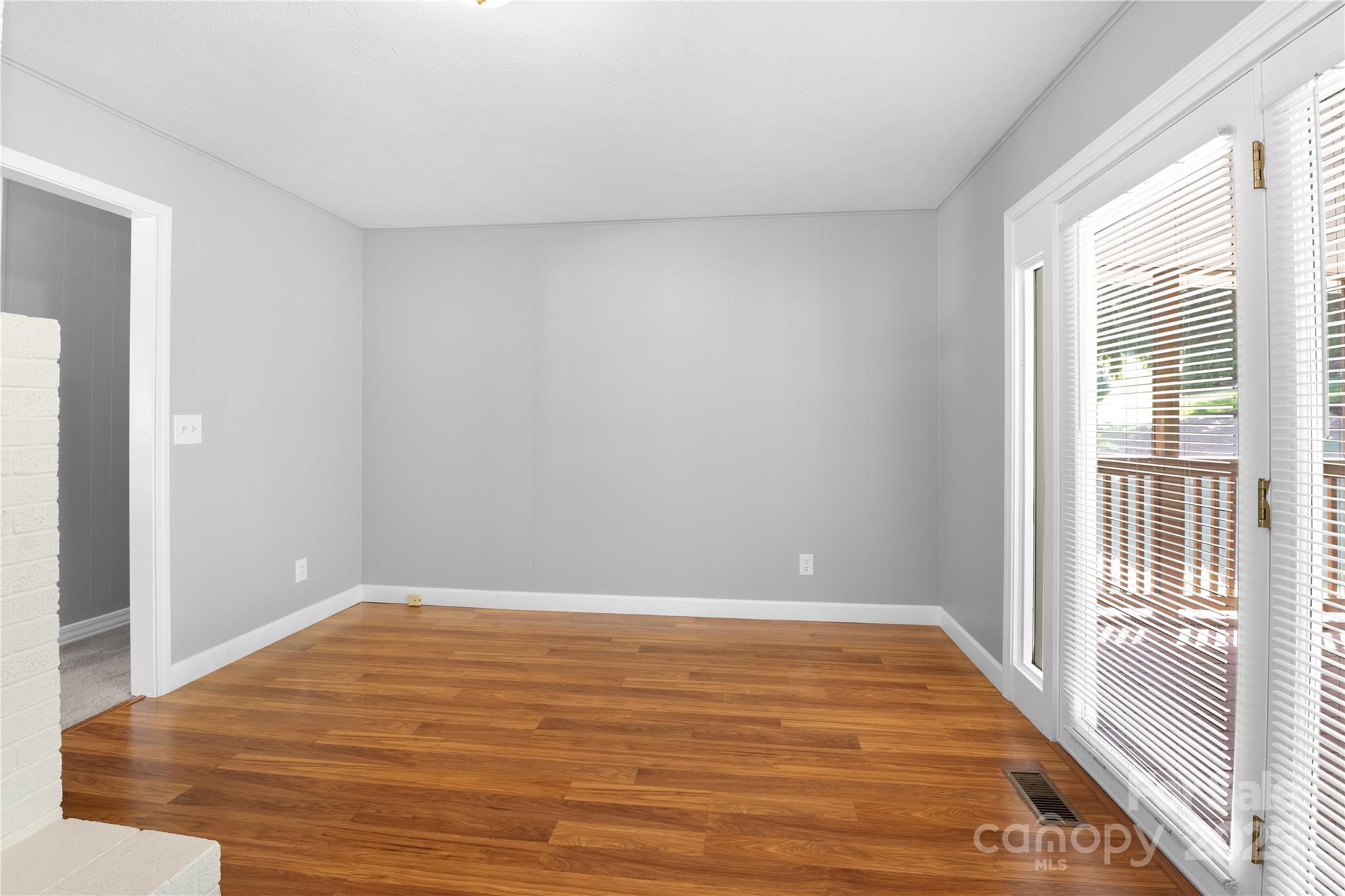 111 Curtis Creek Road Candler, NC 28715 - Photo 10 of 28 a view of empty room with wooden floor and fan