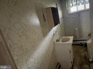 a bathroom with a sink and mirror