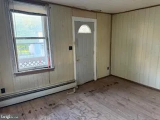 a view of a room with a wooden door
