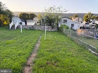 a view of a house with a backyard and a patio