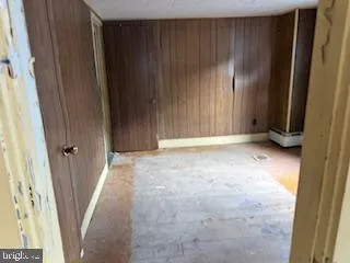 a view of an empty room with wooden door