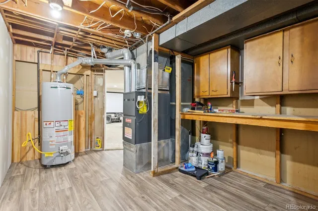 a kitchen with granite countertop a refrigerator and wooden floor