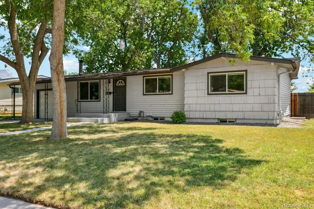 a view of a house with pool and a yard