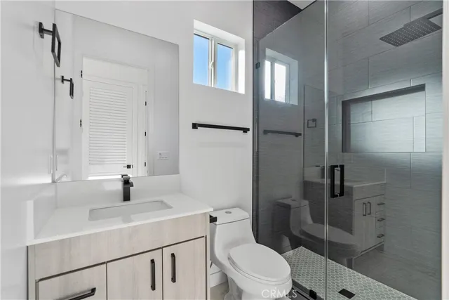 a bathroom with a sink toilet and shower