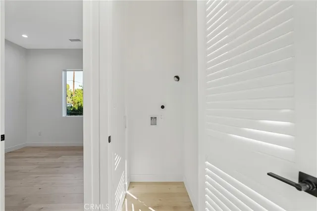 a view of an entryway with wooden floor