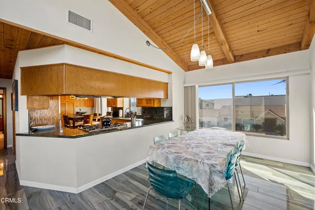 a view of a dining room with a table and chairs