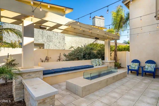 a view of a patio with table and chairs and potted plants
