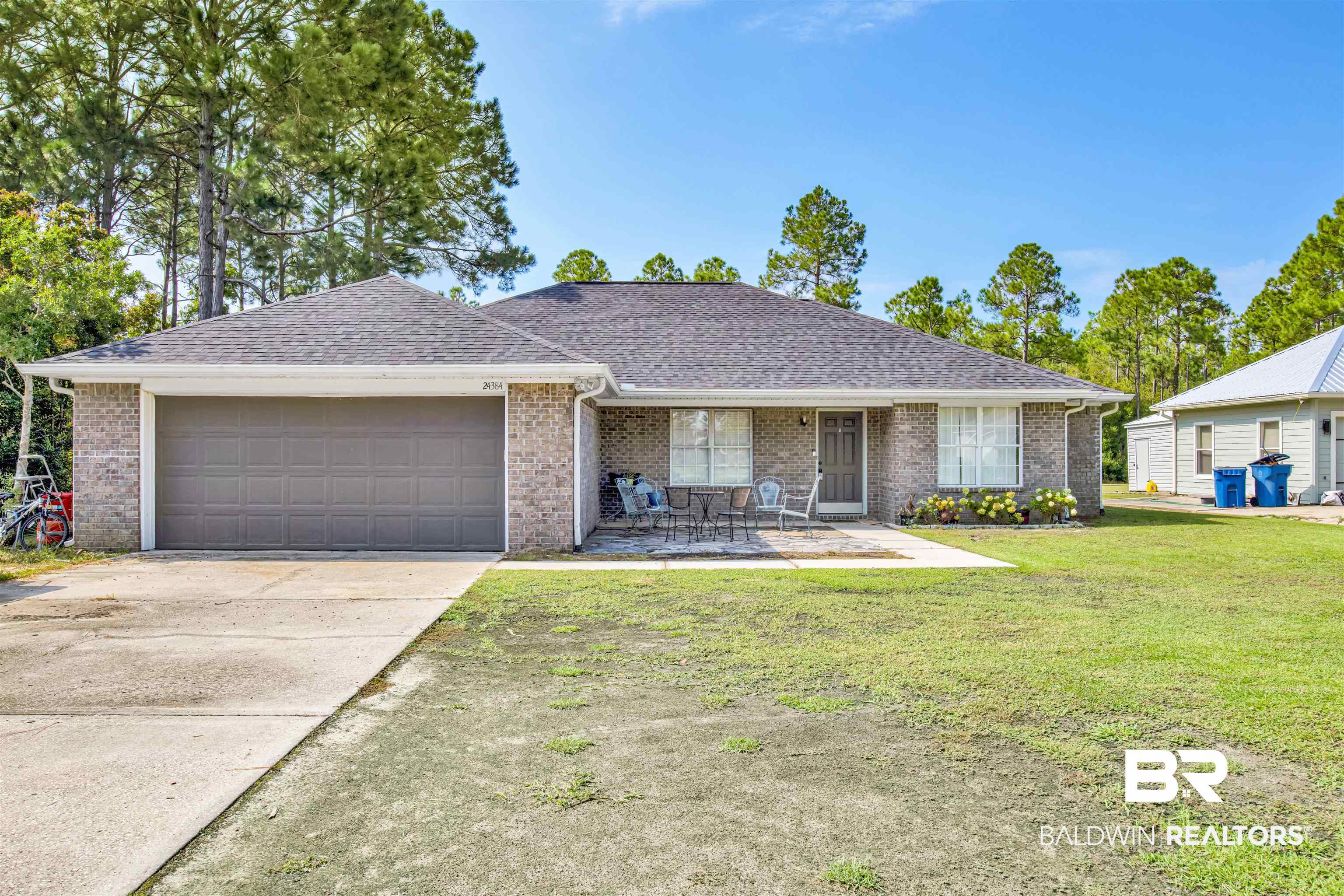 24384 Sailfish Lane Orange Beach, AL 36561 - Photo 1 of 23 Single story home with a garage and a front lawn