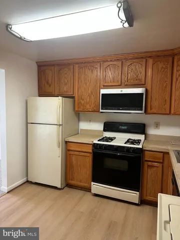 a kitchen with a stove and a refrigerator