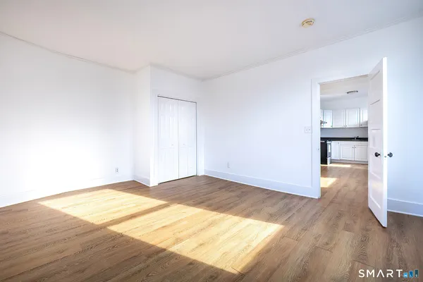 a view of an empty room and wooden floor