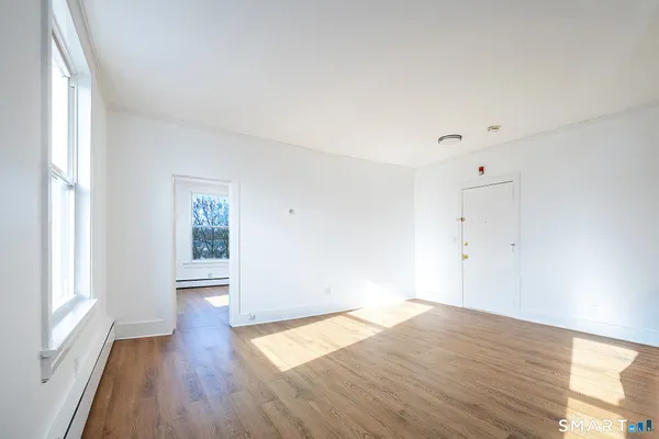 wooden floor in an empty room with a window