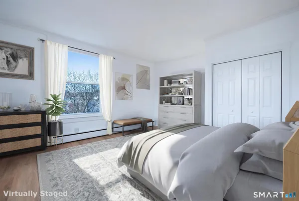 a bedroom with a bed and a window