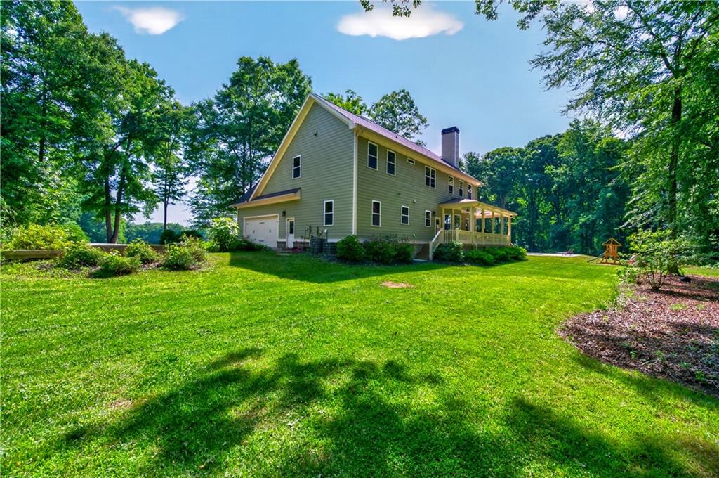 632 Geiger Road Jefferson, GA 30549 - Photo 50 of 55 a front view of a house with garden