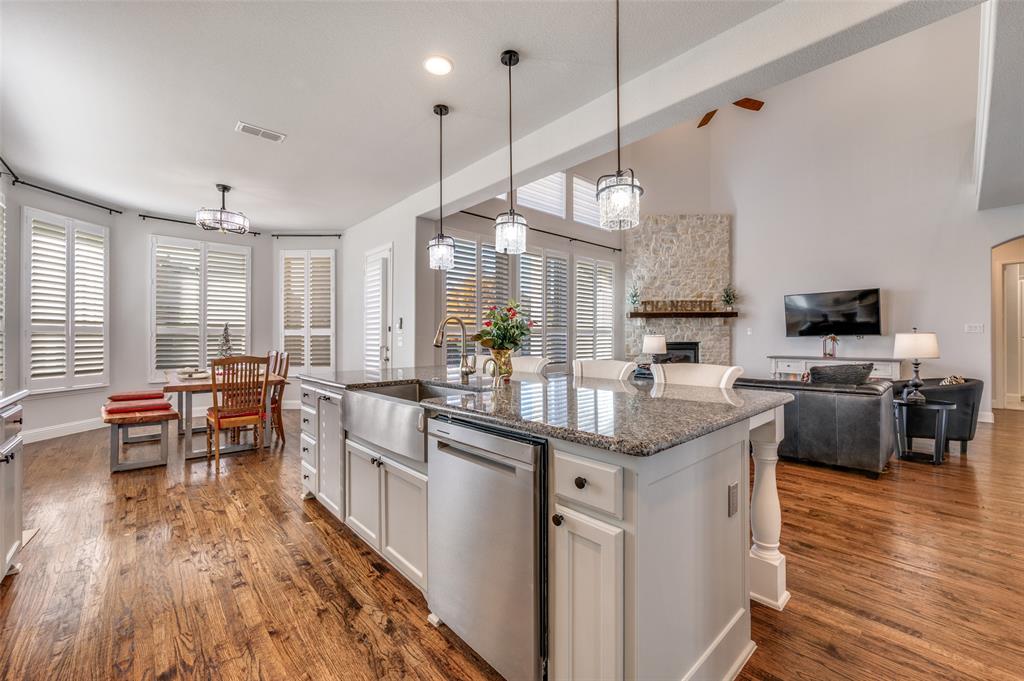 2631 Seabiscuit Road Celina, TX 75009 - Photo 14 of 40 a kitchen with stainless steel appliances granite countertop a sink a stove and a wooden floors
