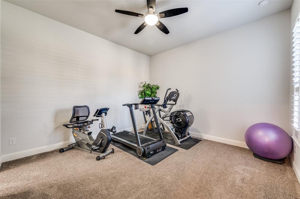 2631 Seabiscuit Road Celina, TX 75009 - Photo 19 of 40 a room with a table and gym equipment