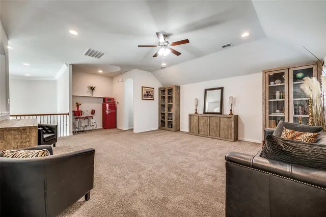 a living room with furniture and kitchen view