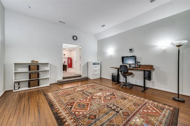 a bedroom with furniture and a wooden floor