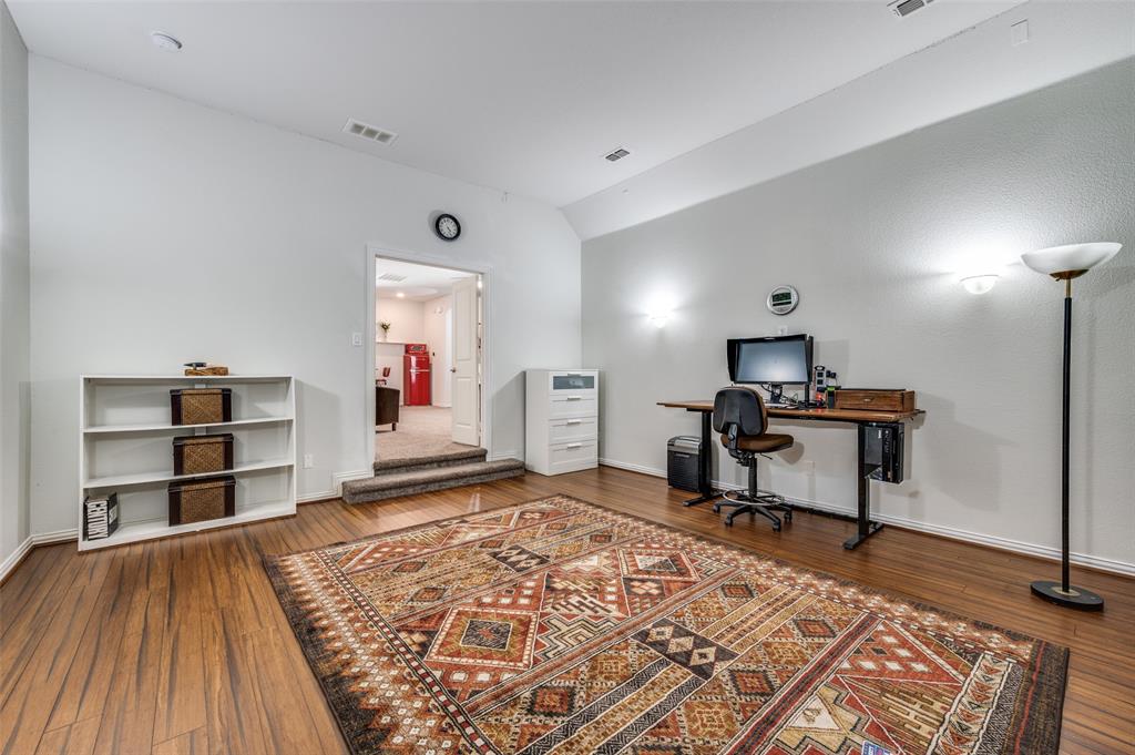 2631 Seabiscuit Road Celina, TX 75009 - Photo 23 of 40 a bedroom with furniture and a wooden floor