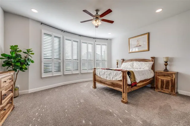 a bedroom with a bed and a potted plant