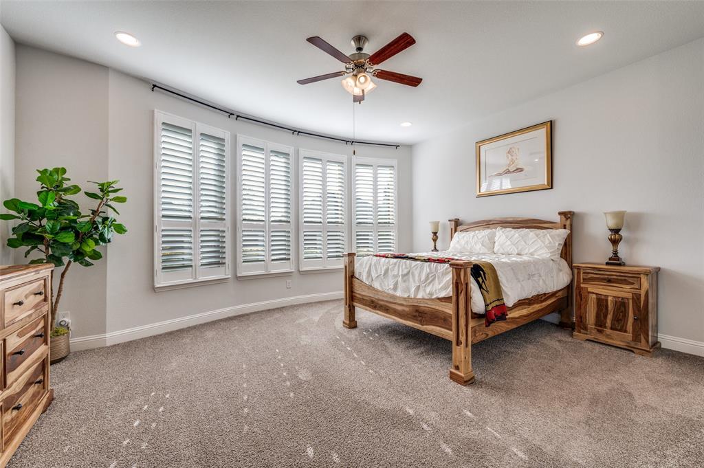 2631 Seabiscuit Road Celina, TX 75009 - Photo 24 of 40 a bedroom with a bed and a potted plant