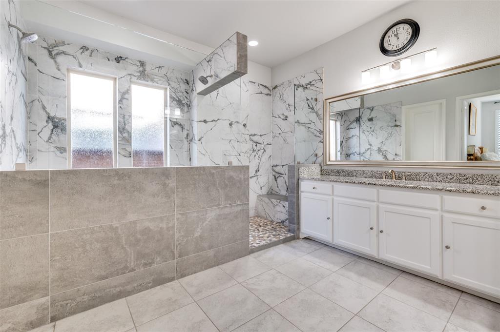 2631 Seabiscuit Road Celina, TX 75009 - Photo 26 of 40 a spacious bathroom with a granite countertop sink a mirror and shower
