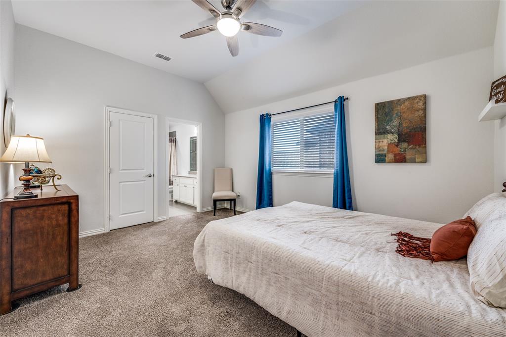 2631 Seabiscuit Road Celina, TX 75009 - Photo 30 of 40 a bedroom with a bed and a chandelier