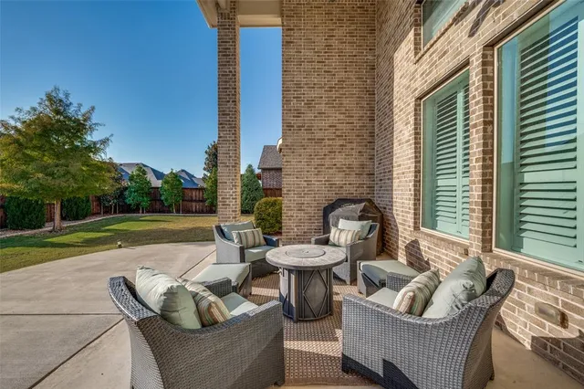 a view of a patio with couches chairs and a fire pit