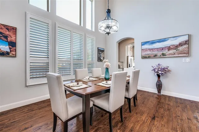 a view of a dining room with furniture wooden floor and chandelier