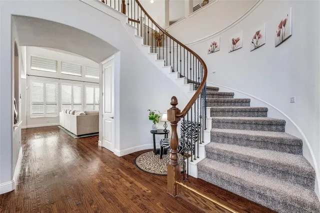 a view of entryway and hall with wooden floor