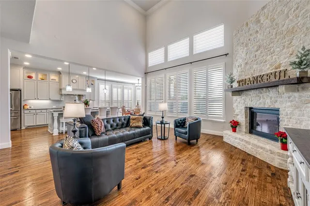 a living room with fireplace furniture and a wooden floor