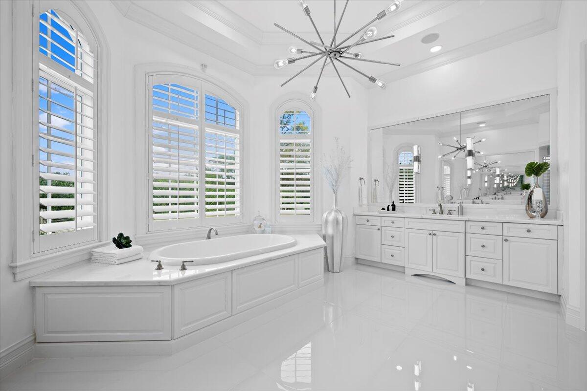 5775 Lady Luck Road Palm Beach Gardens, FL 33418 - Photo 14 of 45 a spacious bathroom with bathtub double vanity windows and a sink
