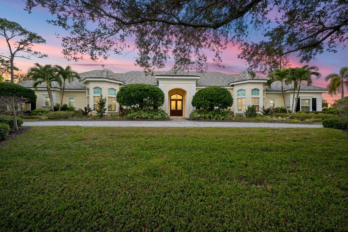 5775 Lady Luck Road Palm Beach Gardens, FL 33418 - Photo 2 of 45 a front view of a house with a yard