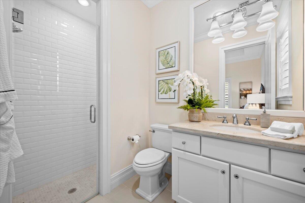 5775 Lady Luck Road Palm Beach Gardens, FL 33418 - Photo 21 of 45 a bathroom with a toilet a sink a shower and mirror