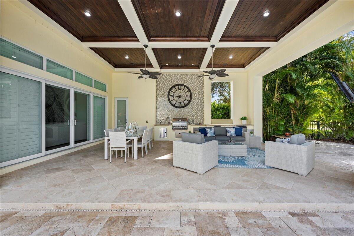 5775 Lady Luck Road Palm Beach Gardens, FL 33418 - Photo 32 of 45 a view of a patio with table and chairs