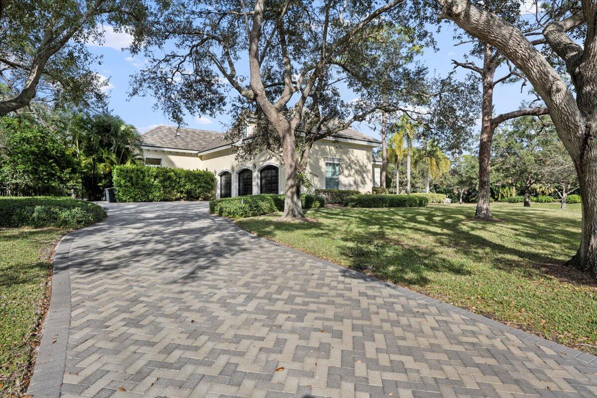 5775 Lady Luck Road Palm Beach Gardens, FL 33418 - Photo 39 of 45 a front view of a building with trees