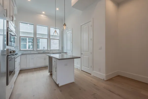 a kitchen with stainless steel appliances a stove microwave and sink