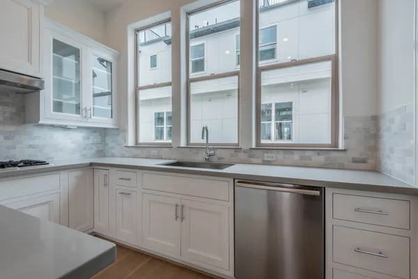 a kitchen with a refrigerator and a sink