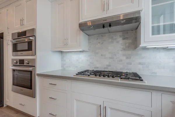 a bathroom with a glass shower door and a mirror