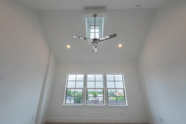 a view of an empty room with closet and a window