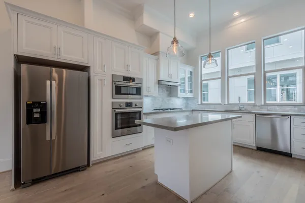 a kitchen with refrigerator and window