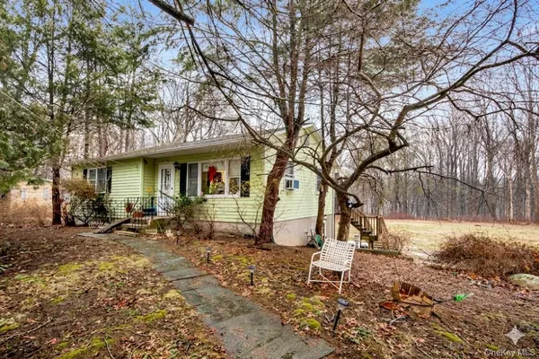 a backyard of a house with table and chairs