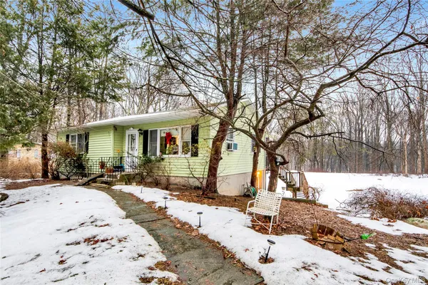 a view of a house with a yard covered in snow