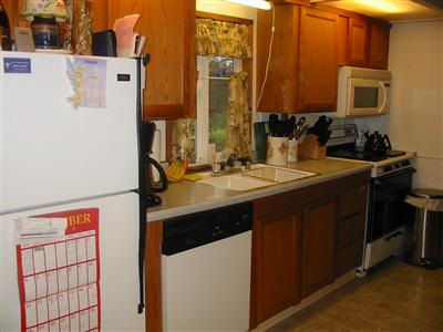 Kitchen with all appliances staying with the home. Kitchen window with view of back yard.