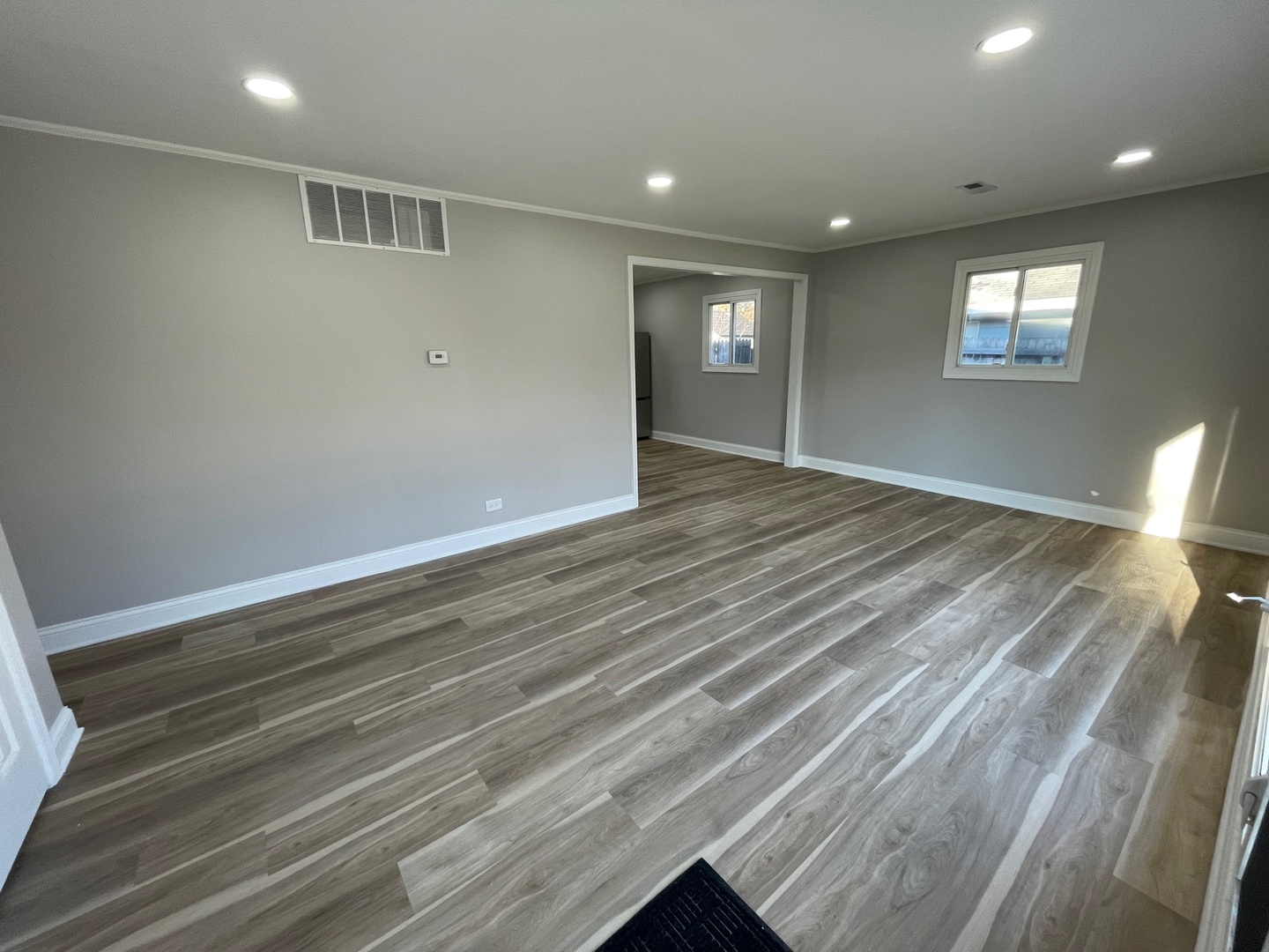 186 Monee Road Park Forest, IL 60466 - Photo 5 of 13 an empty room with wooden floor and windows