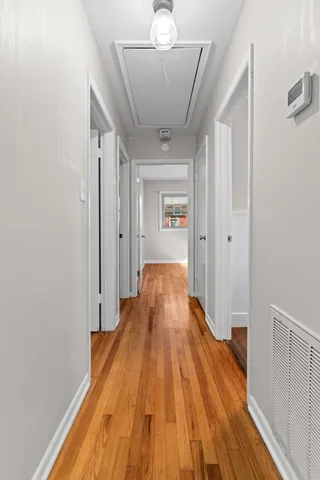 a view of a hallway with wooden floor