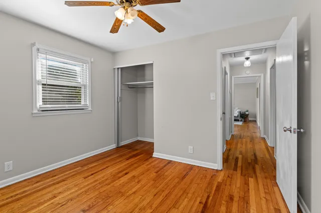 a view of a room with wooden floor and entryway